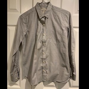 Women’s grey button down dress shirt.